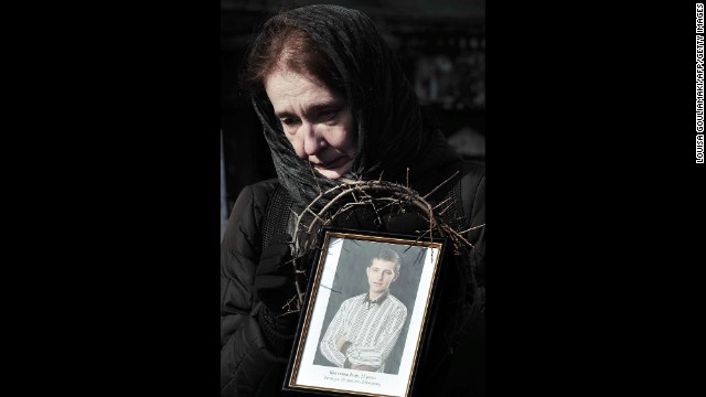 On February 26 in Kiev, a woman holds a photograph of a protester killed during the height of tensions.