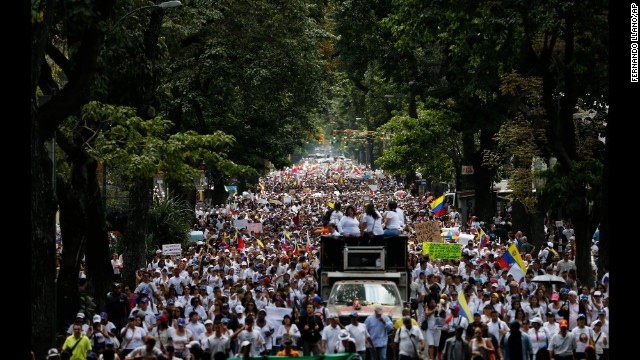 Women march to the National Guard headquarters in Caracas on February 26 to protest what they call excessive use of force against anti-government demonstrations.
