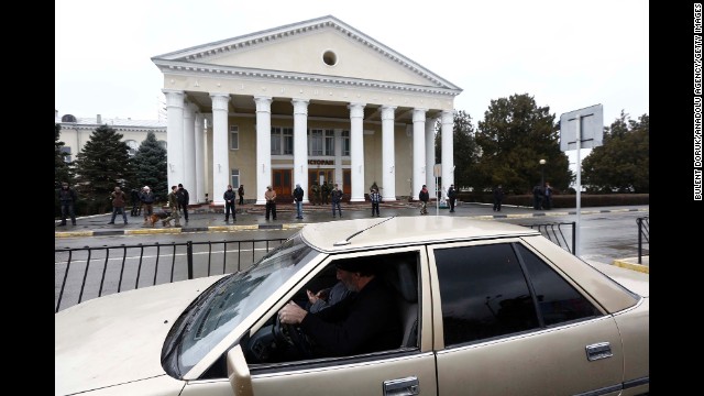 Armed men stand guard in front of a building near the Simferopol airport on February 28. 