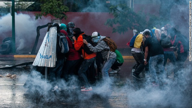 Protesters clash with police forces in Caracas on March 1.