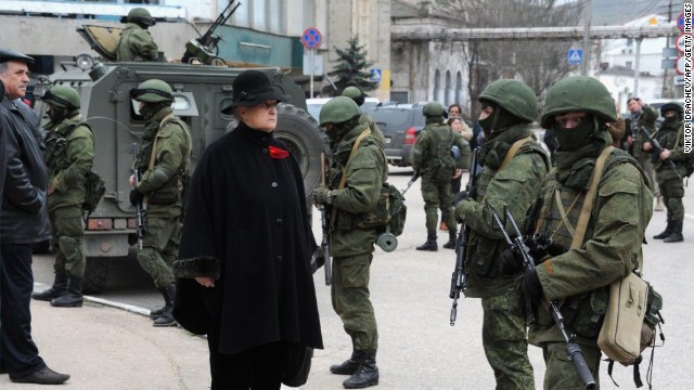 A woman waits in front of unidentified men in military fatigues blocking a base of the Ukrainian frontier guard unit in Balaklava, Ukraine, on March 1. Ukraine suspects Russia of sending new troops into Crimea and provoking separatist tensions in the region. Crimea is an autonomous republic of Ukraine with an ethnic Russian majority. It's the last large bastion of opposition to Ukraine's new political leadership after President Viktor Yanukovych's ouster.