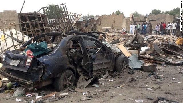 People gather Sunday near the scene of two explosions in Maiduguri, Nigeria.