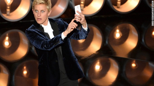 DeGeneres <a href='https://twitter.com/TheEllenShow/status/440302561044594688' >takes a selfie</a> on stage near the start of the show.