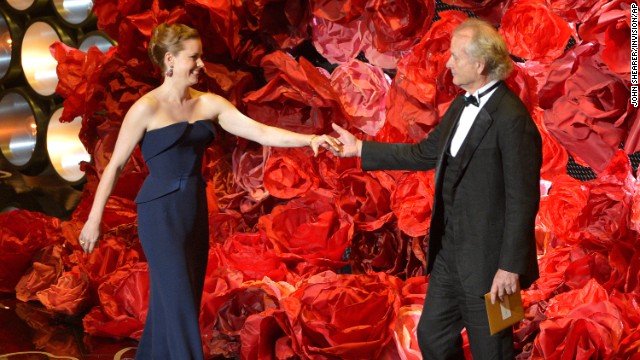 Amy Adams greets Bill Murray on stage. While reading the names of those nominated for best achievement in cinematography, Murray also mentioned director <a href='http://www.cnn.com/2014/02/24/showbiz/movies/obit-harold-ramis/index.html'>Harold Ramis</a>, his "Ghostbusters" co-star who died last month at the age of 69.