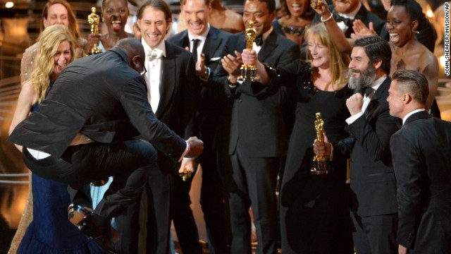 Director Steve McQueen, left, celebrates with the cast and crew of "12 Years a Slave" as they accept the Academy Award for best picture.