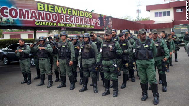 National Guard officers stand in formation after a patrol in Valencia, Venezuela, on Saturday, March 1.