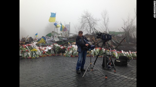 KIEV, UKRAINE: CNN Cameraman Christian Streib sets up for live shots by the barricades on the road to Independence Square on March 4. Photo by CNN's Jon Steward. 