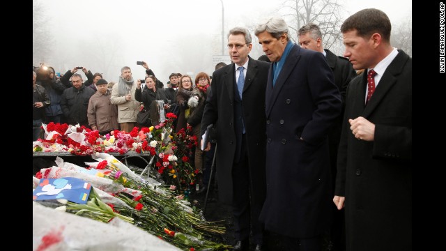 U.S. Secretary of State John Kerry, wearing a blue scarf, visits a shrine March 4 for the people who were killed in February during anti-government protests in Kiev.