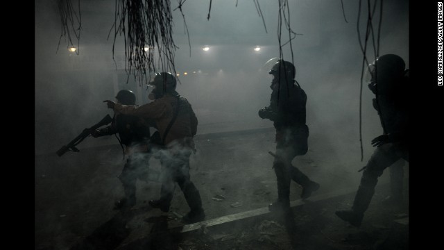 National Guard members throw tear gas canisters toward opposition activists in Caracas on March 3.