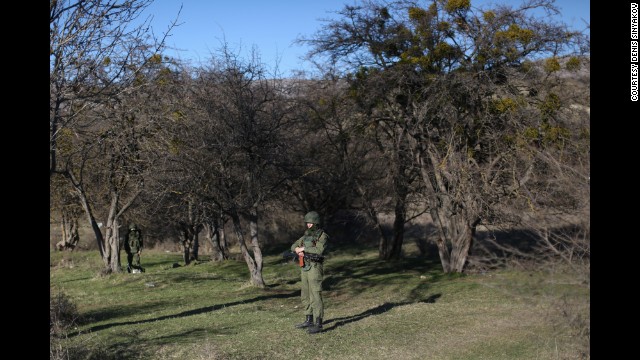 A Russian soldier guards an area outside Ukraine's military base in the village of Perevalne on March 3.