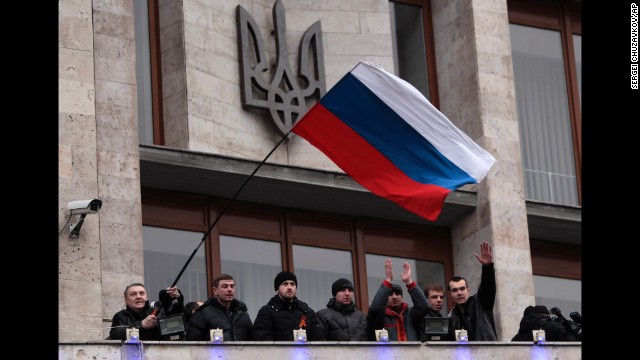 Pro-Russia demonstrators wave a Russian flag after storming a regional administrative building in Donetsk on March 5.