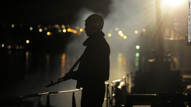 A sailor guards the Ukrainian Navy ship Slavutych in the Bay of Sevastopol on Wednesday, March 5. Ukrainian officials and Western diplomats accuse Russia of sending thousands of troops into the region in the past week -- a claim Russia has denied. The crisis in the former Soviet republic has revived concerns of a return to Cold War relationships. Follow the evolving story on <a href='http://cnnworldlive.cnn.com/Event/Crisis_in_Ukraine_2?hpt=hp_t1'>CNN's live blog</a>.
