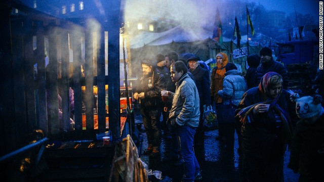 People wait in line for food distribution at Independence Square in Kiev on March 5.