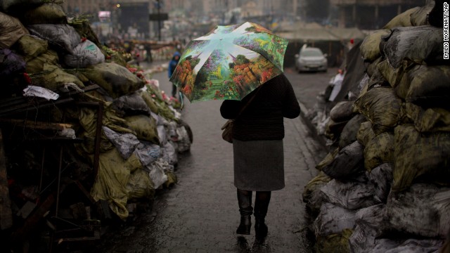 A woman walks past barricades March 6 that were set up by anti-government protesters in Kiev's Independence Square.