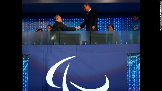 Sir Philip Craven, the president of the International Paralympic Committee, shakes hands with Russian President Vladimir Putin, right.