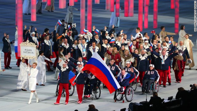 Russian athletes, led by skier and flag bearer Valerii Redkozubov, enter the stadium.