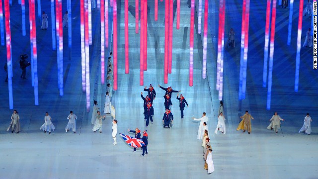 Skier Millie Knight leads Great Britain into the stadium.