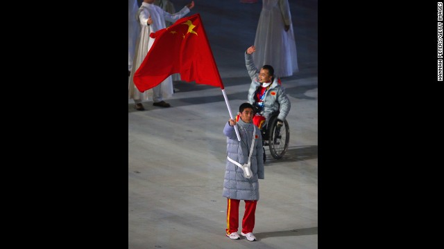 Chinese skier Ye Tian holds his country's flag.