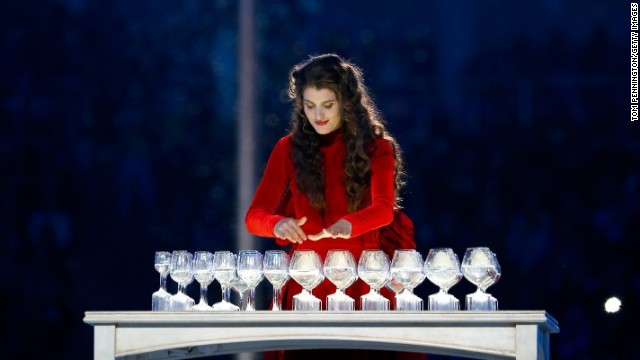 A musician performs using drink glasses. 