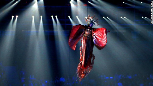 Performers "fly" above the stadium.