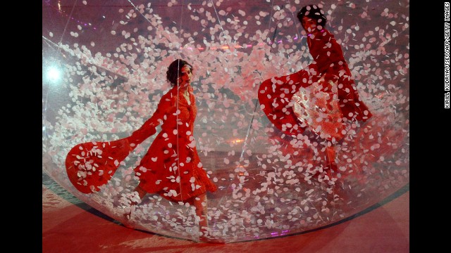 Artists perform in giant spheres.