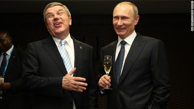 Putin, right, and International Olympic Committee President Thomas Bach laugh during the ceremony.