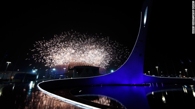 Fireworks explode over the stadium at the start of the event.