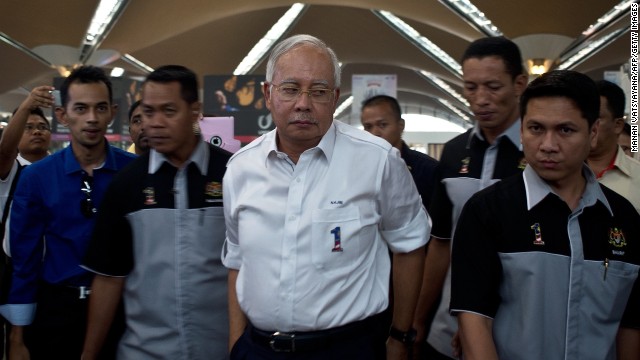 Malaysian Prime Minister Najib Razak, center, arrives to meet family members of missing passengers at the reception center at Kuala Lumpur International Airport on March 8.