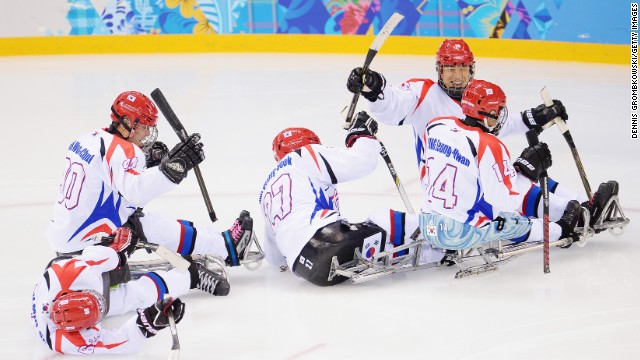 The Korean team celebrates their second goal during an ice sledge hockey match against Russia on March 8.