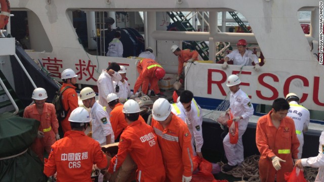 Members of a Chinese emergency response team board a rescue vessel at the port of Sanya in China's Hainan province on March 9. The vessel is carrying 12 divers and will rendezvous with another rescue vessel on its way to the area where contact was lost with Malaysia Airlines Flight 370.