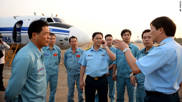 Vietnamese air force crew stand in front of a plane at Tan Son Nhat airport in Ho Chi Minh City on March 9 before heading out to the area between Vietnam and Malaysia where the airliner vanished.