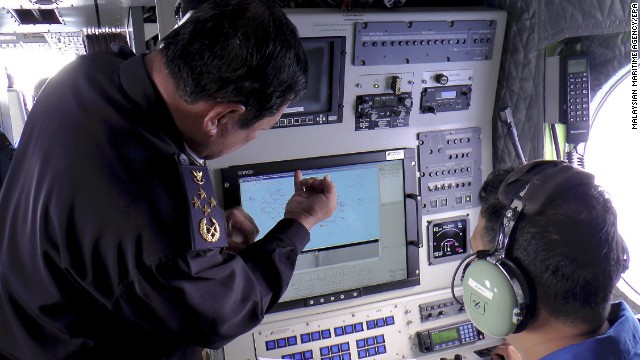 A handout picture provided by the Malaysian Maritime Enforcement Agency shows personnel checking a radar screen during search-and-rescue operations March 9.