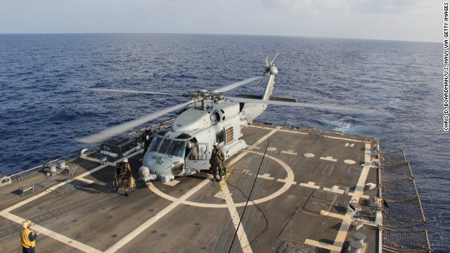 A U.S. Navy Seahawk helicopter lands aboard the USS Pinckney to change crews before returning to search for the missing plane Sunday, March 9, in the Gulf of Thailand.