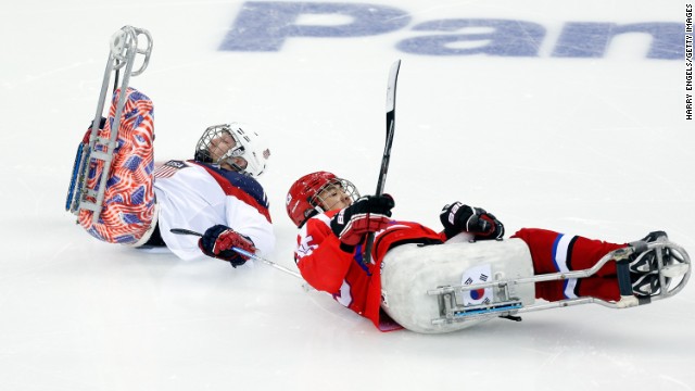 Tyler Carron of the United States, left, collides with Jong Ho-jang of South Korea during a ice sledge hockey game on March 9. 