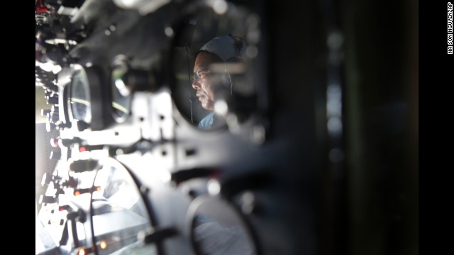 Vietnam air force Col. Le Huu Hanh is reflected on the navigation control panel of a plane that is part of the search operation over the South China Sea on March 10.