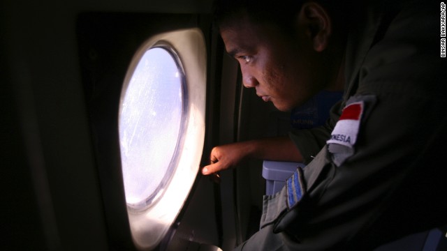 An Indonesian navy crew member scans an area of the South China Sea bordering Indonesia, Malaysia and Thailand on Monday, March 10.