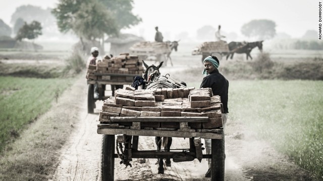 These images were part of a project by animal charity The Brooke -- here working mules and their drivers depart from a brick kiln close to Aligarh, an Indian city near Delhi.