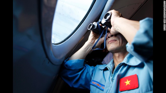 A Vietnamese military official looks out an aircraft window during search operations March 13.