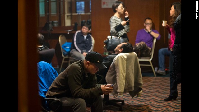 Relatives of missing passengers wait for the latest news at a hotel in Beijing on March 12.