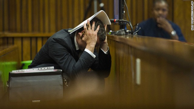 Oscar Pistorius covers his head as he listens to forensic evidence during his trial in Pretoria, South Africa, on Thursday, March 13. Pistorius, the first amputee to compete in the Olympics, is accused of murdering his girlfriend, Reeva Steenkamp, on February 14, 2013.