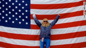 Caitlin Sarubbi, a disabled U.S. skier, stands before a flag at the 2010 Winter Paralympic Games in Vancouver.