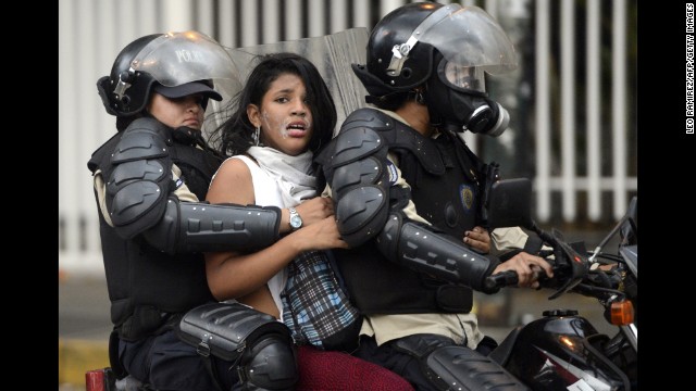 An activist is taken by police during an anti-government protest in Caracas on March 13.