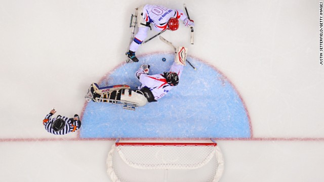 Goalie Man-Gyun Yu and defender Young-Jae Cho of South Korea stop Sweden from scoring in a hockey game March 14.