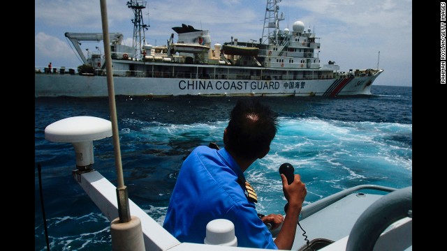 A member of the Malaysian navy makes a call as his ship approaches a Chinese coast guard ship in the South China Sea on March 15.