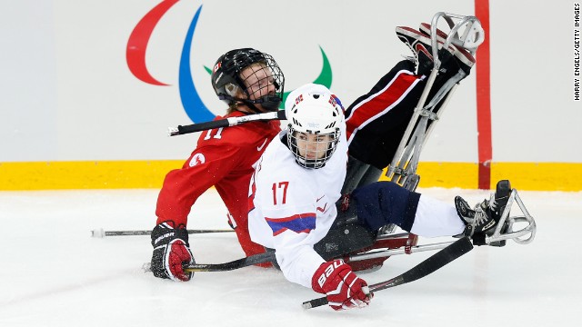 Loyd-Remi Pallander Solberg of Norway, left, collides with Adam Dixon of Canada during the ice sledge hockey bronze medal match at Shayba Arena during the Paralympic Winter Games on Saturday, March 15, in Sochi, Russia.