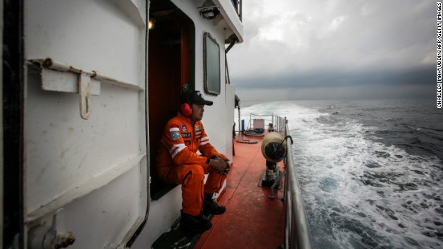 Indonesian personnel watch over high seas during a search operation in the Andaman Sea on Saturday, March 15.