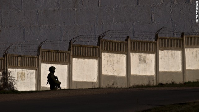 A pro-Russian soldier guards the perimeter outside an Ukrainian military base in Perevalne on March 15.