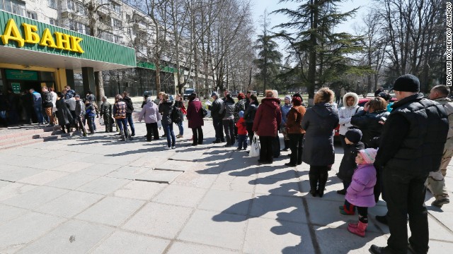 People stand in line to vote at a bank office in Simferopol, Ukraine. Results are expected on Monday. The United States has already said it expects the Black Sea peninsula's majority ethnic Russian population to vote in favor of joining Russia.