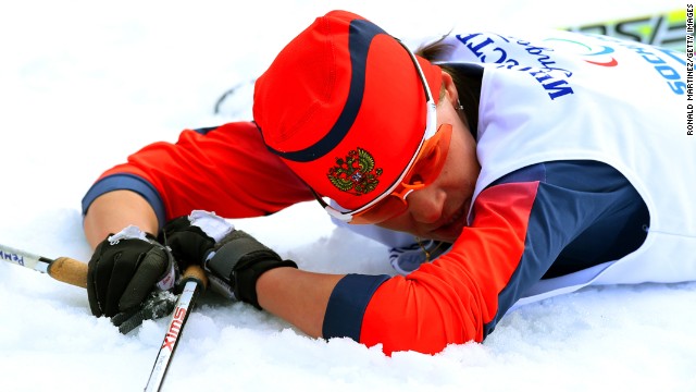 Gold medalist Elena Remizova of Russia collapses after crossing the finish line in the women's cross-country 5-kilometer free visually impaired event.