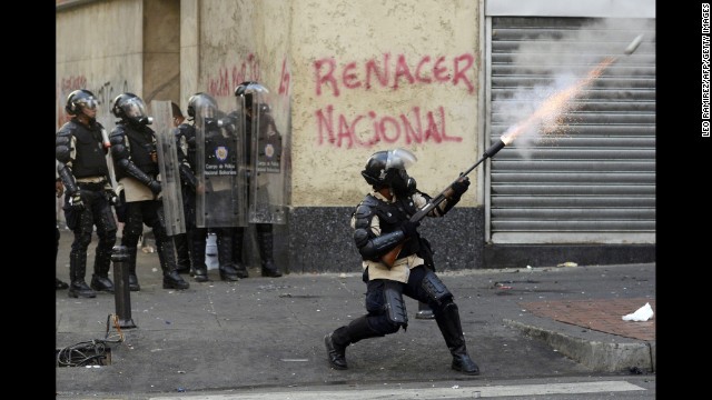 Riot police face off with students in Caracas on March 15.